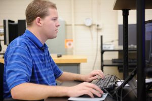 Student research analyzing data at a PC workstation