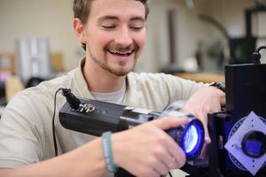 Student research aligning a blue LED for pressure coating testing