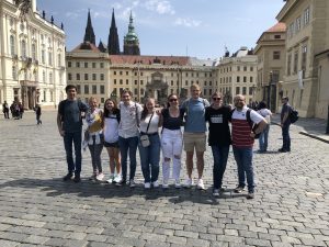 A group of people standing in a European looking town square
